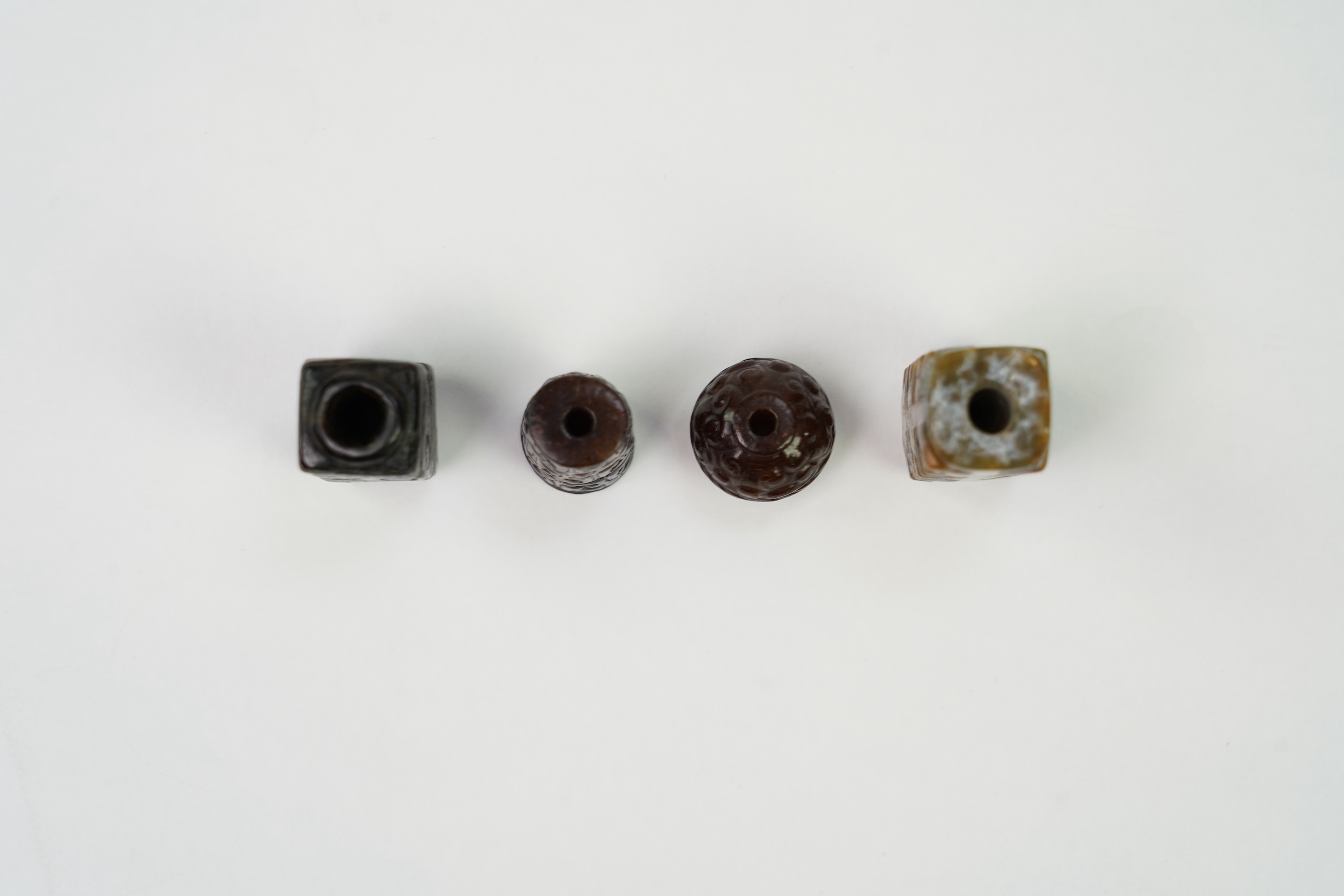 A group of four Chinese archaistic jade beads